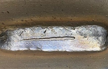 Closeup showing a worm track across the top of a weld