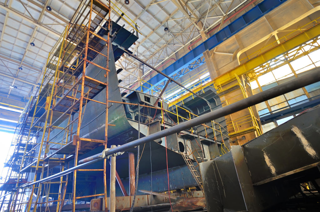 Environmental photo of a portion of a ship with scaffolding around it
