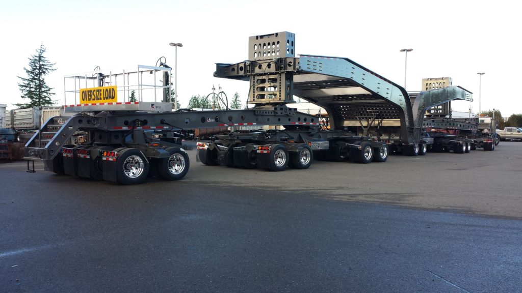 Side view of oversized multi-axle black trailer 